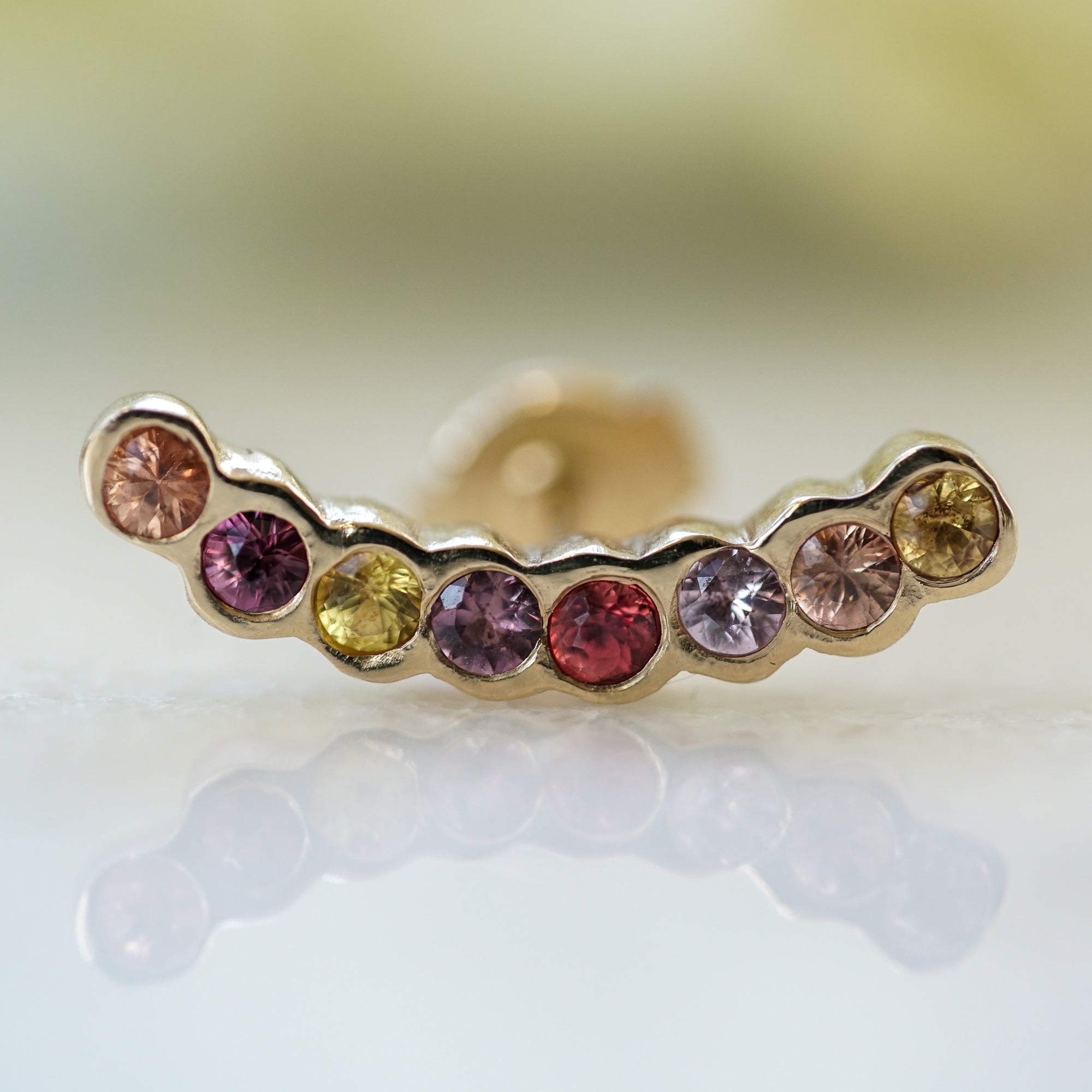 multicolor sapphires set in gold for a gorgeous ear climber