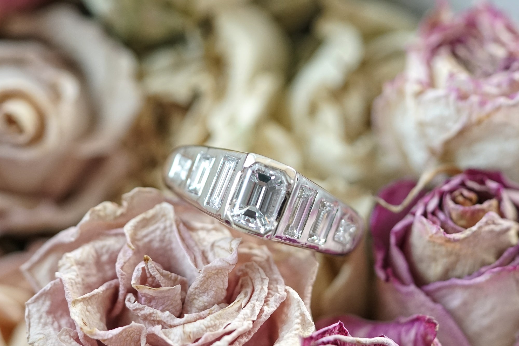 engagement ring with emerald cut diamond and baguette and princess cut diamonds in a very modern design