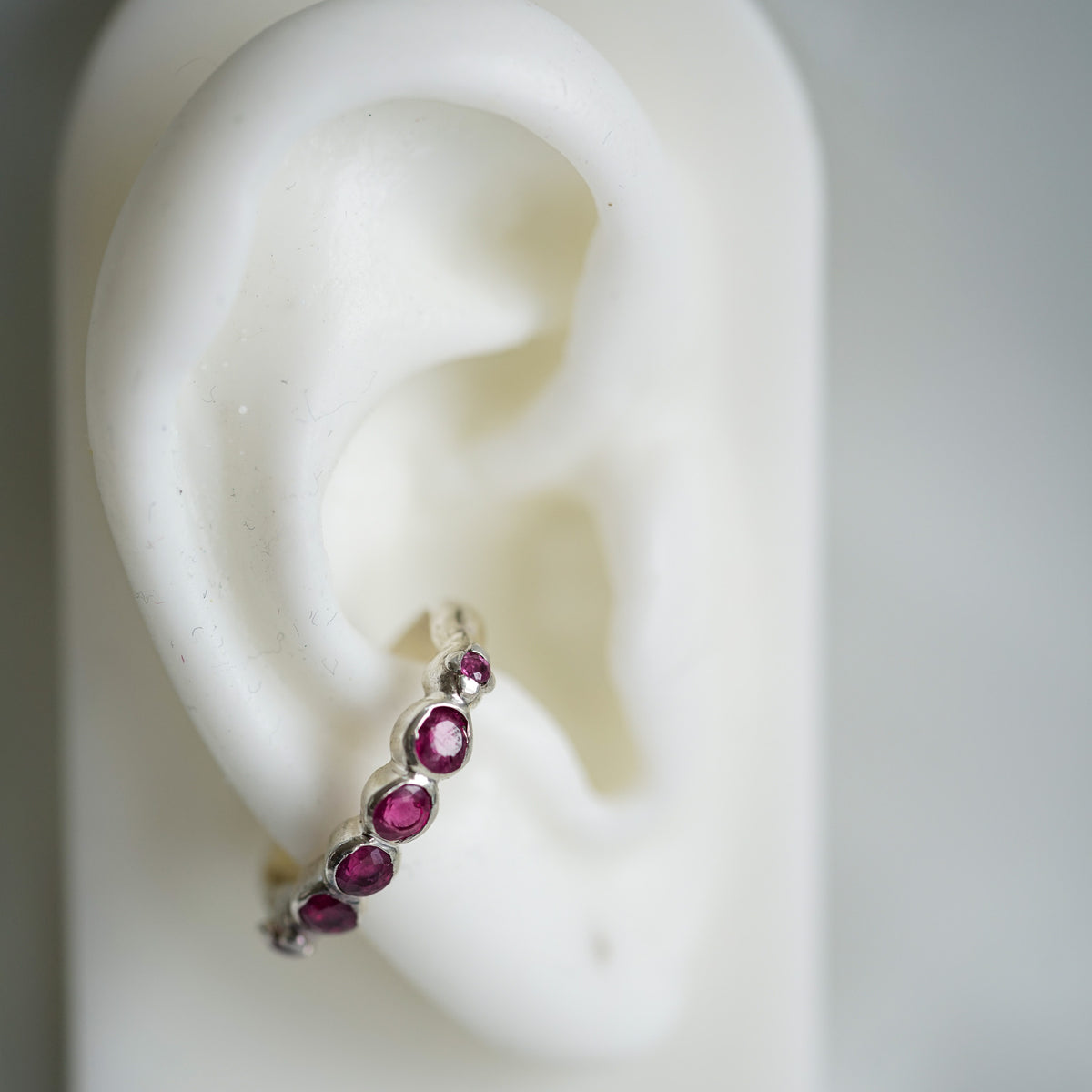 acfj silver ear cuff with rubies n a ear lobe