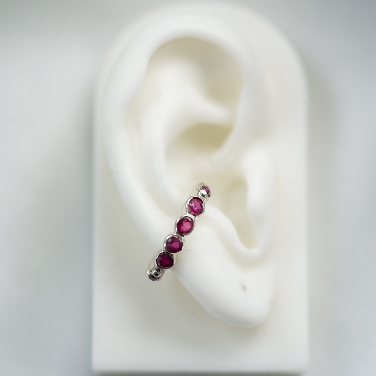 acfj silver ear cuff with rubies on a ear lobe