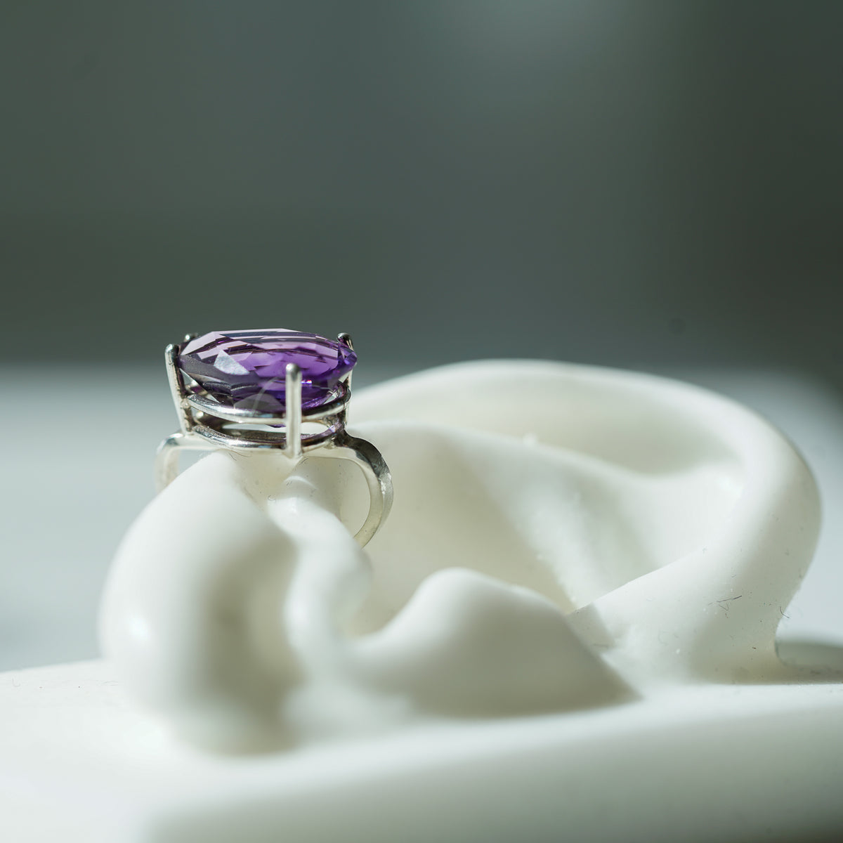 ear cuff in sterling silver with a pear shaped amethyst 