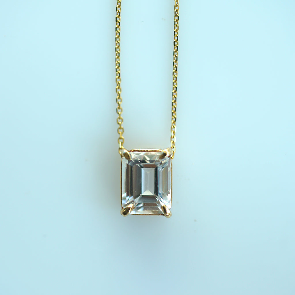 White topaz emerald cut gold necklace