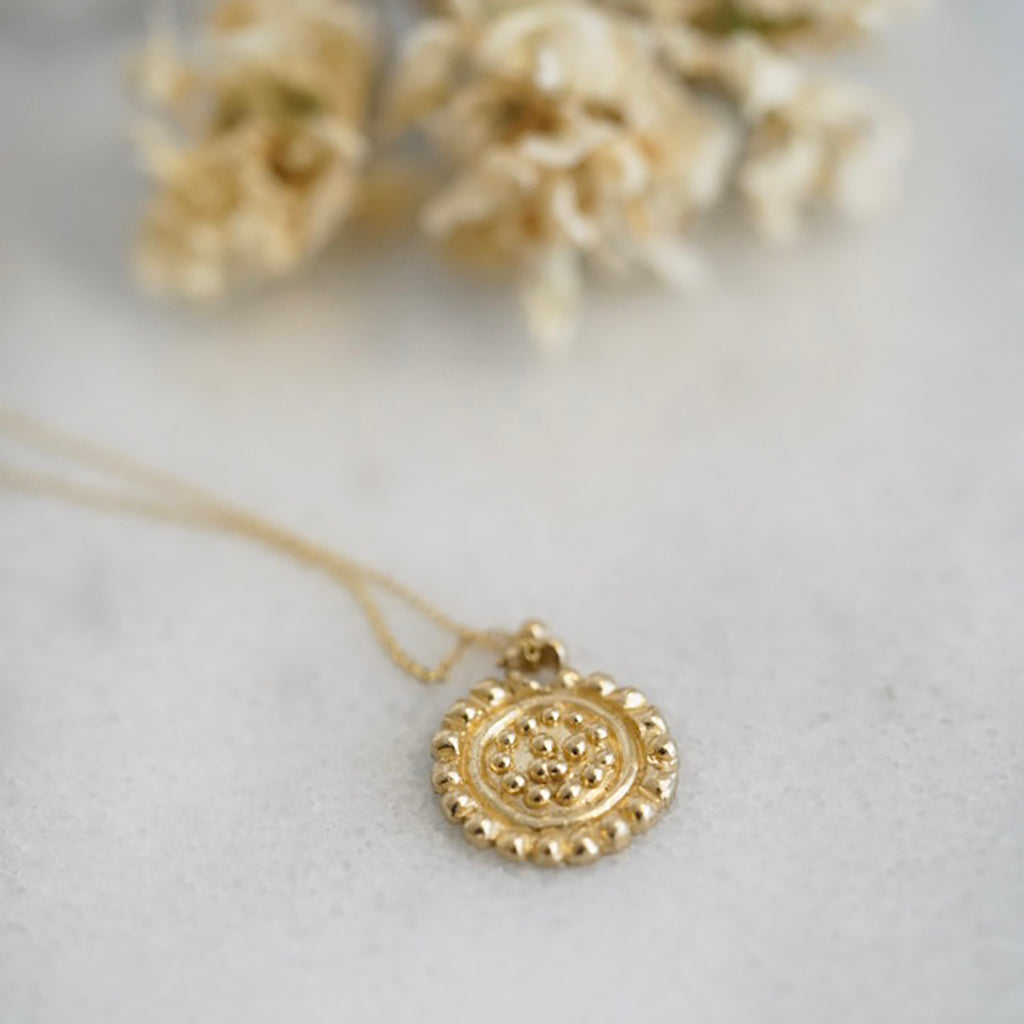 Large dots gold medallion