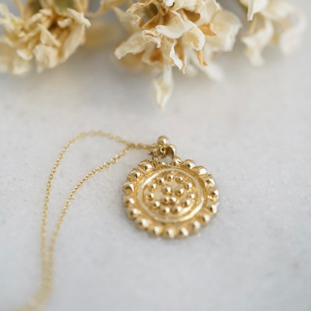 Large dots gold medallion